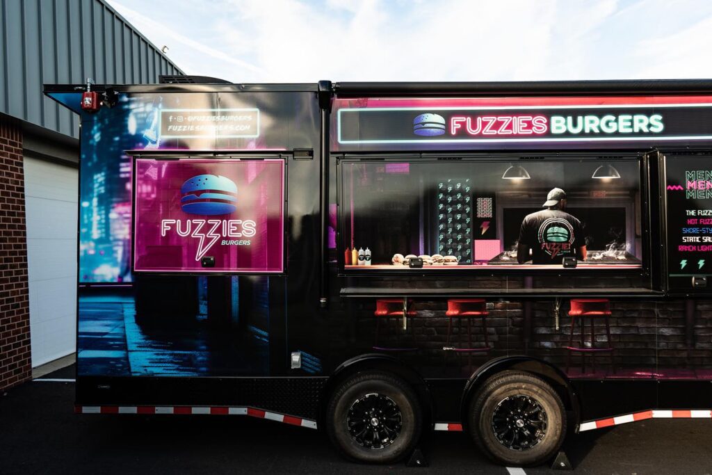 A food trailer with a person inside.